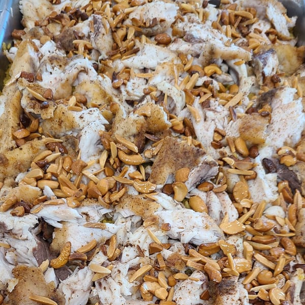 Close-up of Lebanese fish with toasted almonds and spices, ready to be served.